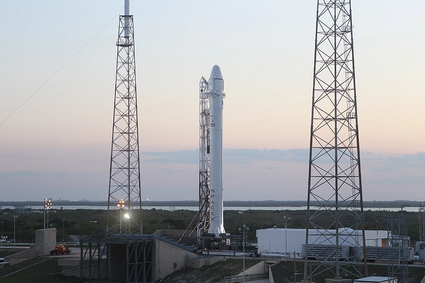 SpaceX Falcon 9 rocket on launchpad at dusk