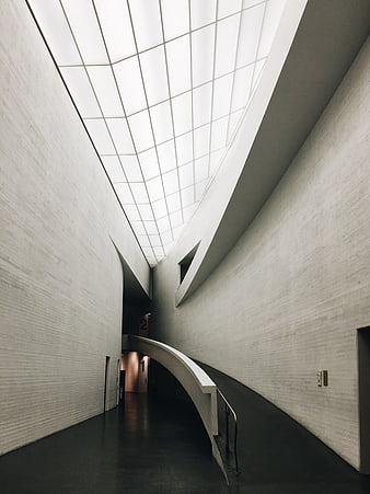 Modern minimalist architecture with curved ramp and skylight