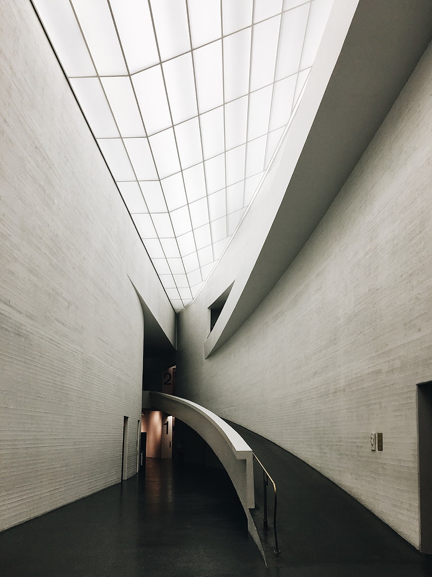 Modern minimalist architecture with curved ramp and skylight