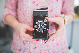 Woman Holding Vintage Ikon Folding Camera