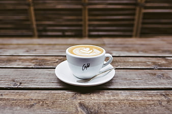 White Latte Cup With Heart Art On Rustic Wooden Table