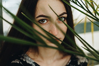 Mysterious Woman Portrait Through Green Palm Leaves