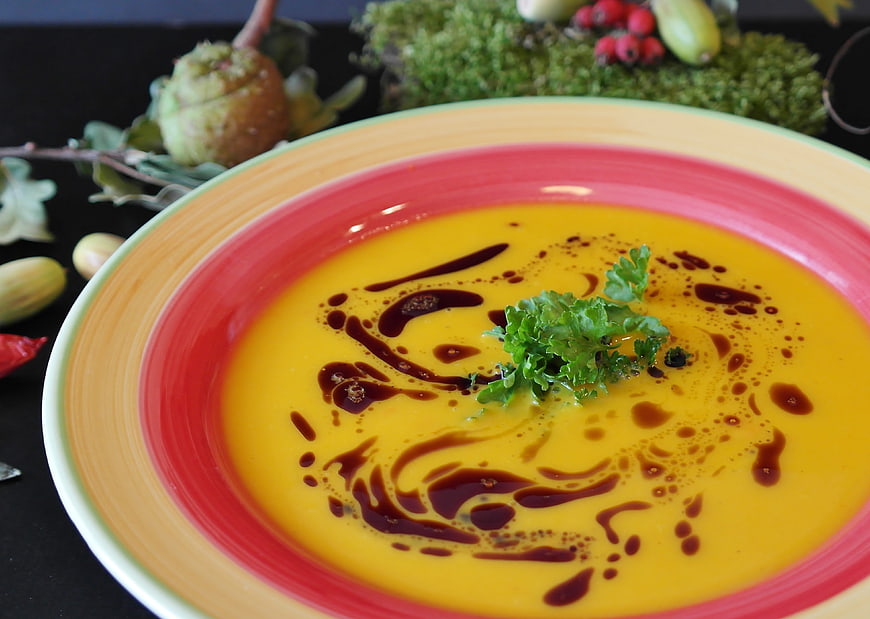 Creamy Pumpkin Soup with Balsamic Drizzle and Parsley Garnish