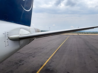 Airplane Wing and Tail on Airport Runway