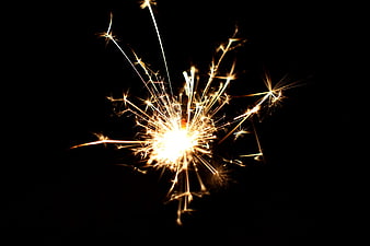 Sparkler Burning Bright Against Black Background