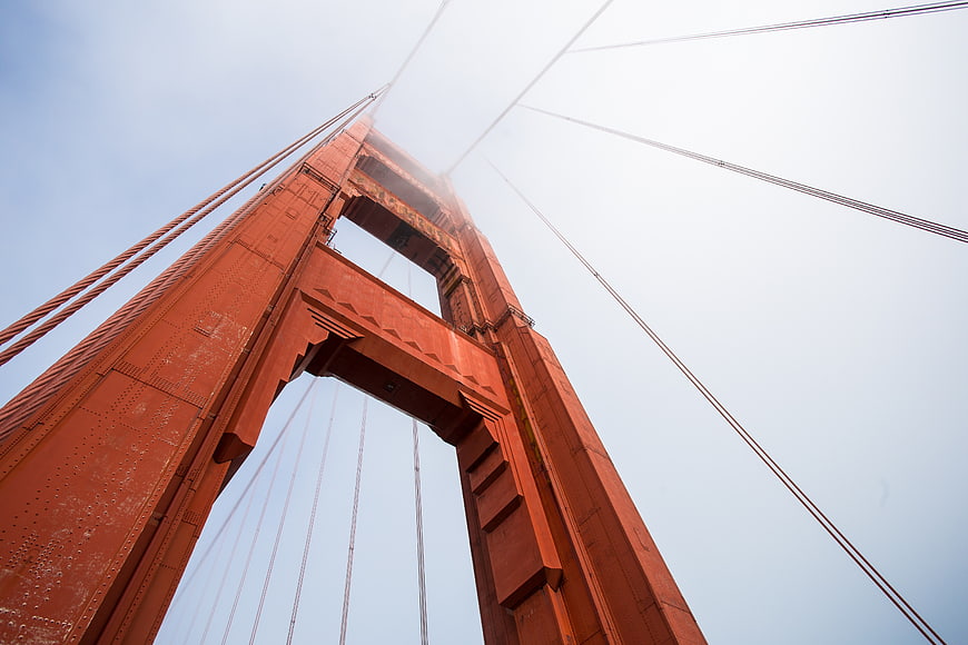 Low angle view of Golden Gate Bridge tower in fog