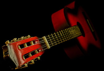 Close-up of Red Classical Guitar Headstock on Black Background