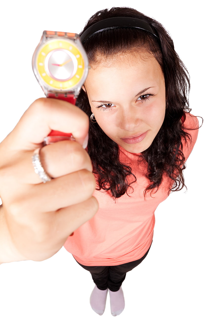 Young Woman Pointing Watch Upward From High Angle White Background