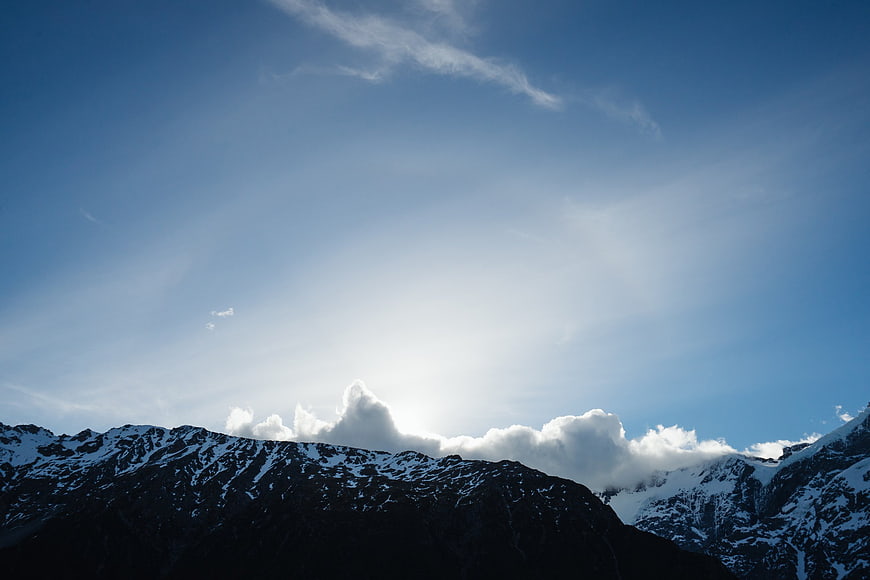 Snow-Capped Mountain Peaks Against a Bright Blue Sky