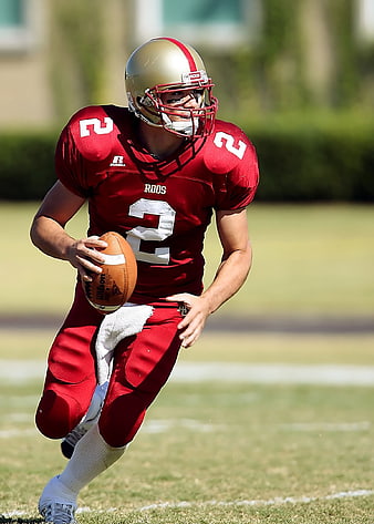 American Football Player Running with Ball on Field