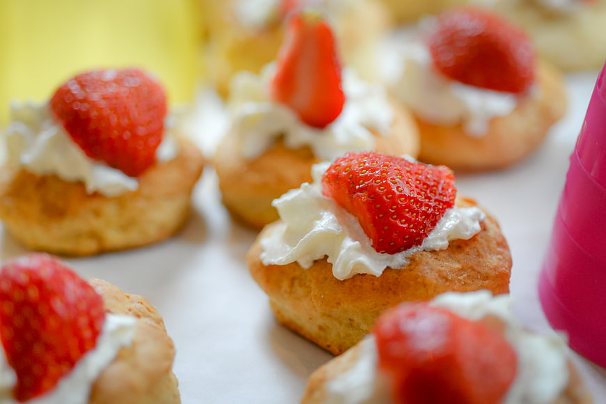 Fresh strawberry cream puffs on a white table