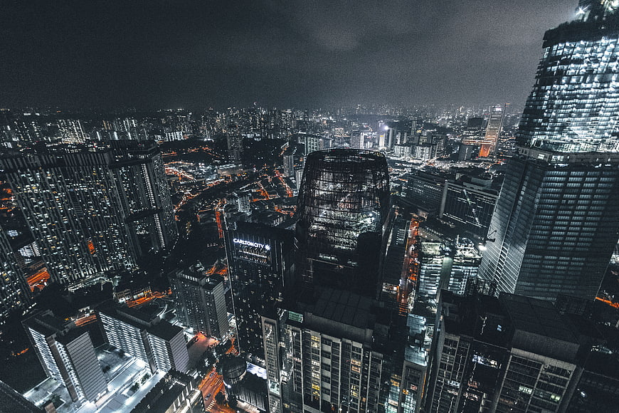 Aerial Night View of Modern City Skyscrapers and Urban Lights