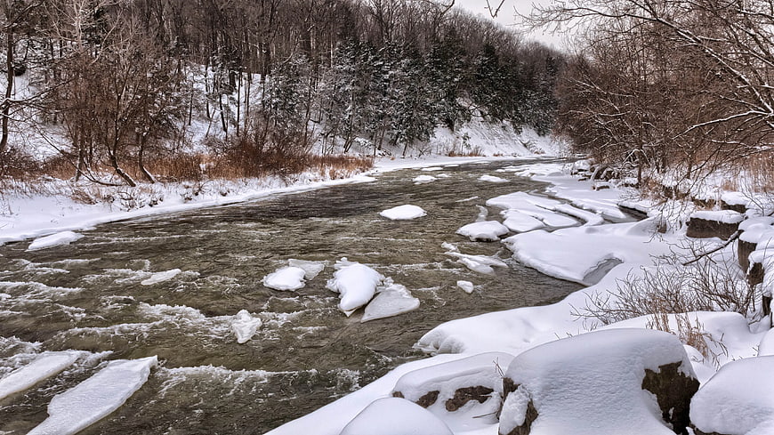 Snowy River Flowing Through Winter Forest Landscape