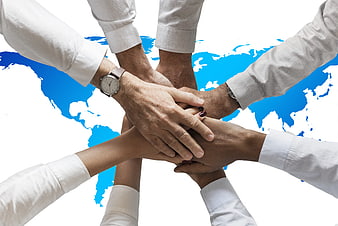 Diverse Hands Stacked Together Over World Map Background