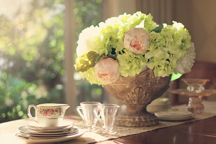 Vintage floral arrangement with hydrangeas and peonies on a table
