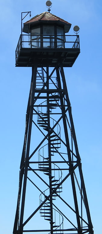 Metal Guard Tower with Spiral Staircase Against Blue Sky