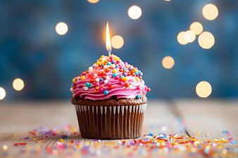Colorful Birthday Cupcake with Candle and Sprinkles