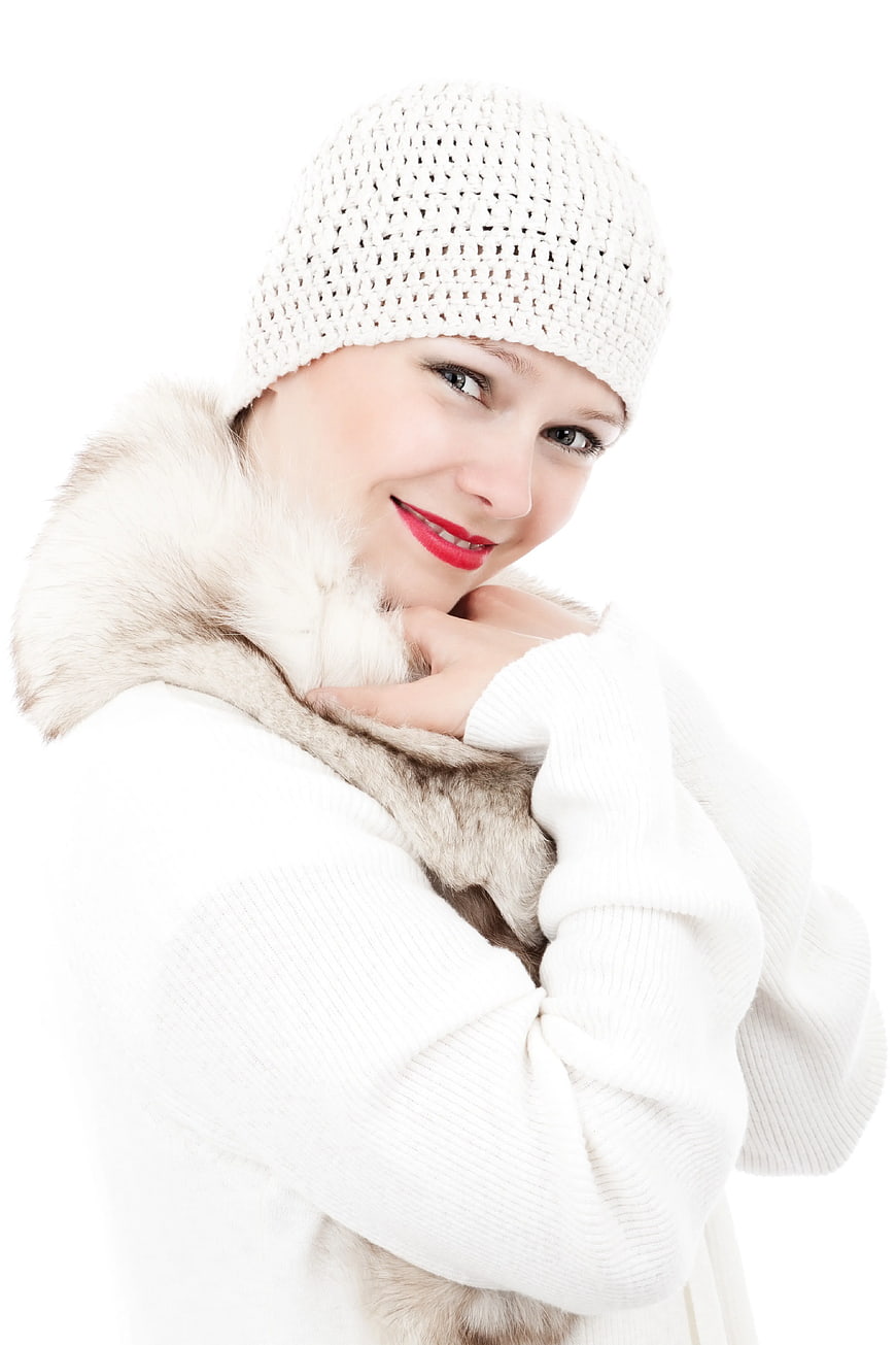Smiling Woman in White Knit Hat and Fur Coat