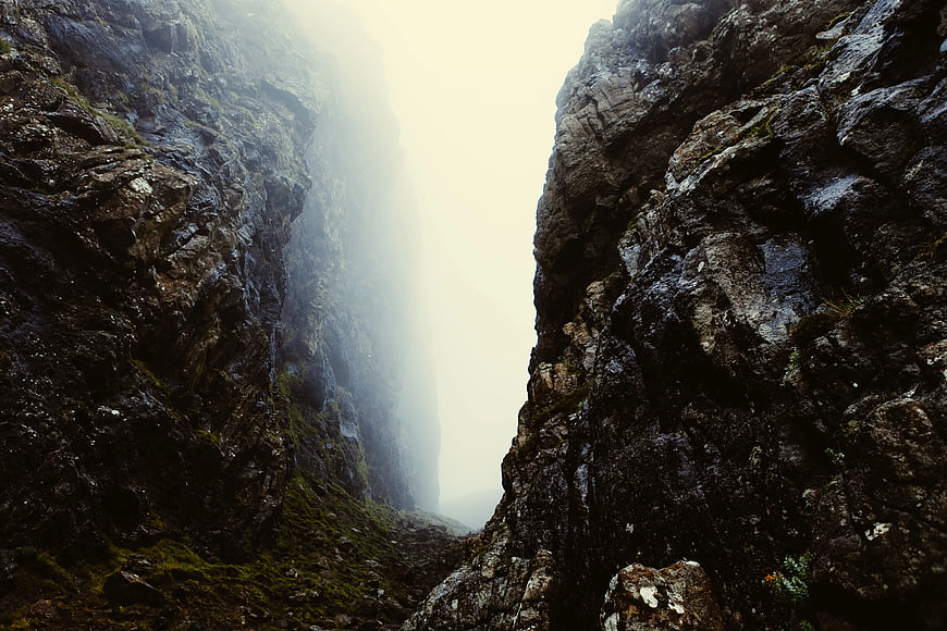 Misty Mountain Gorge with Dark Rocky Cliffs