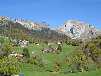 Scenic Swiss Mountain Village in Autumn with Green Hills
