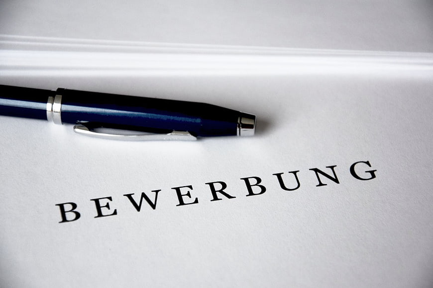 Blue pen on German job application document Bewerbung