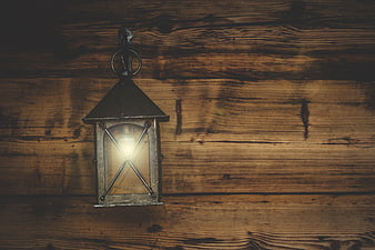 Vintage Lantern on Rustic Wooden Wall Background