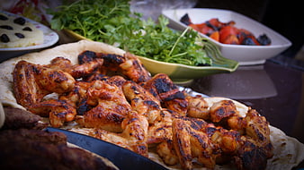 Grilled Chicken Wings and Fresh Herbs on a Feast Table