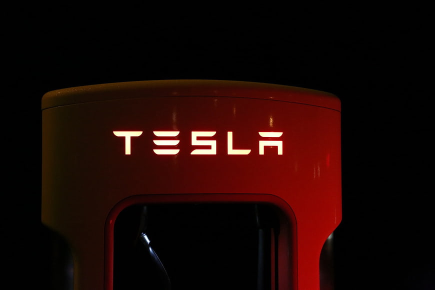 Illuminated Tesla Supercharger Logo at Night