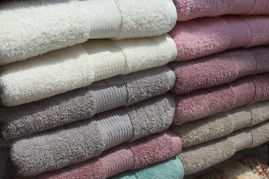 Stacked Multicolored Cotton Bath Towels In Soft Natural Light