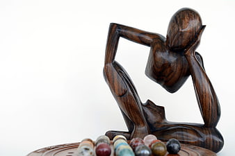Wooden Thinker Sculpture With Marbles On White Background