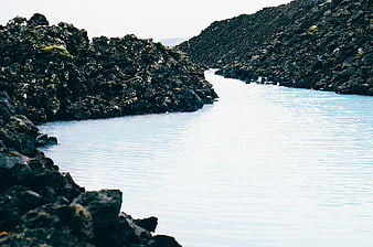 Milky Blue Lagoon Surrounded by Dark Volcanic Rocks