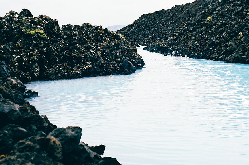 Milky Blue Lagoon Surrounded by Dark Volcanic Rocks