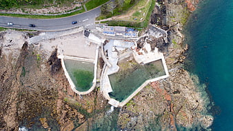 Aerial view of coastal rock pools and cliffside road