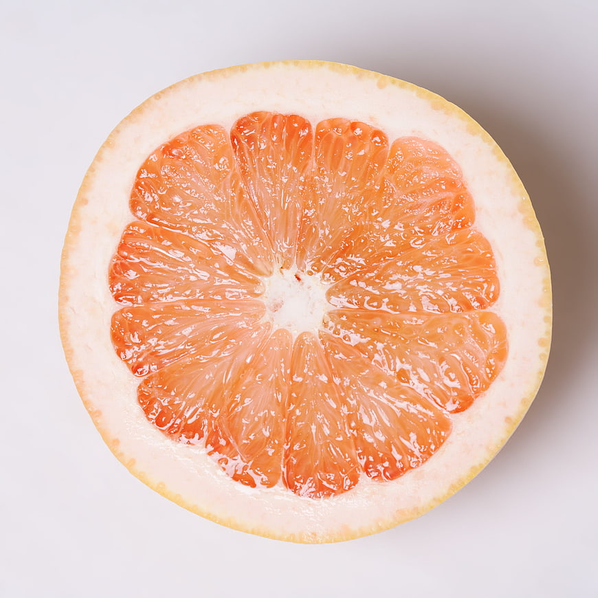 Top-Down View of Fresh Pink Grapefruit Half on White Background