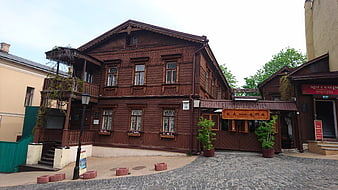 Traditional Wooden Restaurant Building on Cobblestone Street