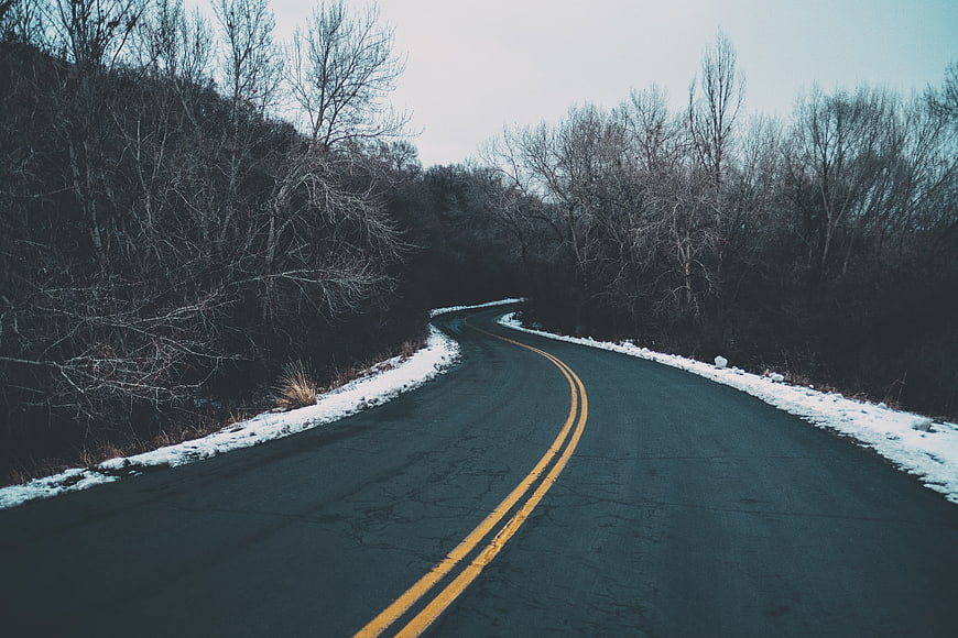 Winding Winter Road Through Snowy Forest