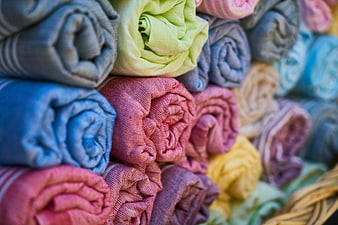 Colorful Rolled Towels in Wicker Basket Closeup