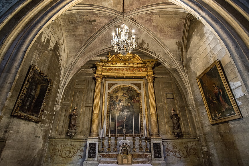 Gothic church interior with golden altar and vaulted ceiling