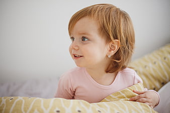 Cute Redhead Toddler Girl Smiling in Bed