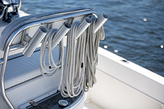 Close-up of coiled ropes on yacht cleats