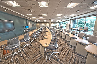 Modern empty university lecture hall with rows of desks and chairs