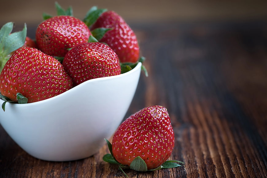 Fresh Strawberries in White Bowl on Wooden Table