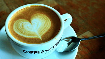 Latte Art Heart Pattern in White Coffee Cup on Wooden Table
