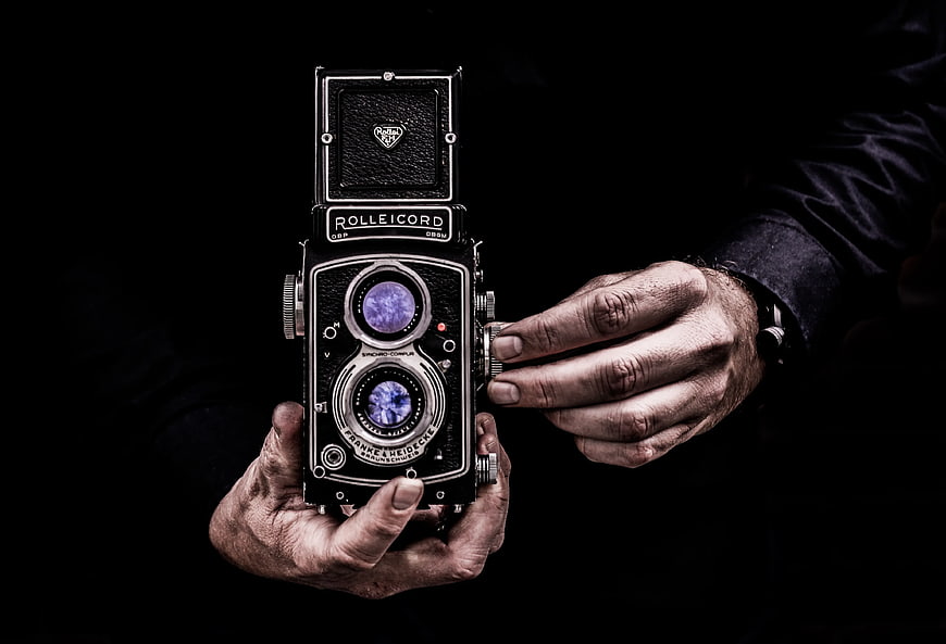Vintage Rolleicord Camera Held by Hands