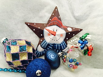 Christmas ornaments and snowman star decoration on snow