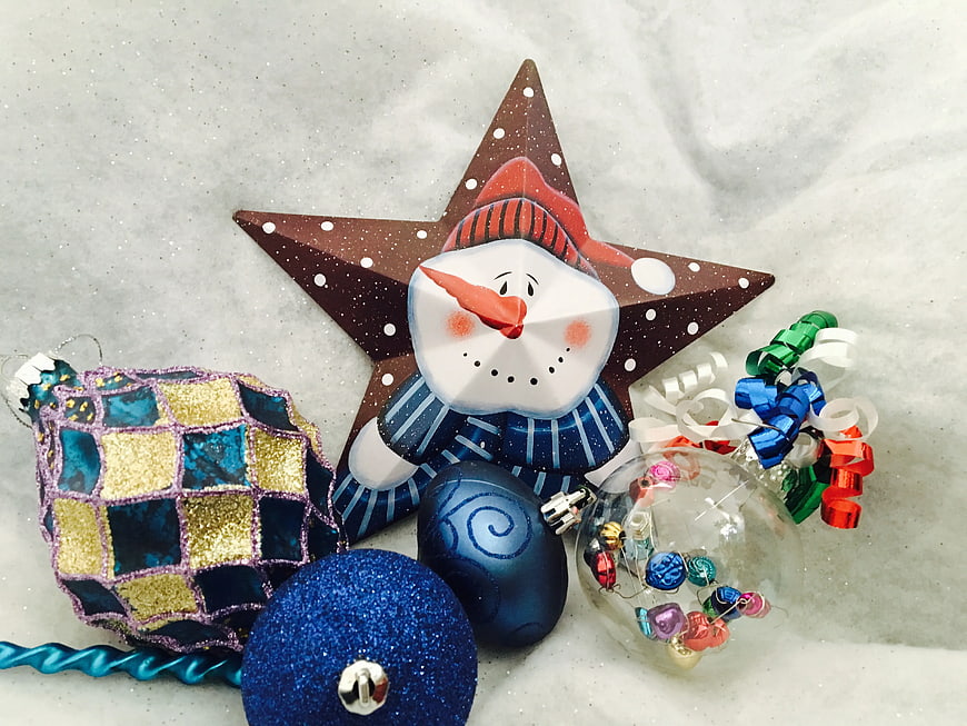 Christmas ornaments and snowman star decoration on snow