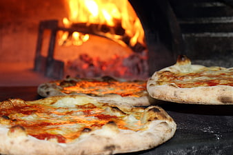 Freshly Baked Wood-Fired Pizzas in a Pizzeria
