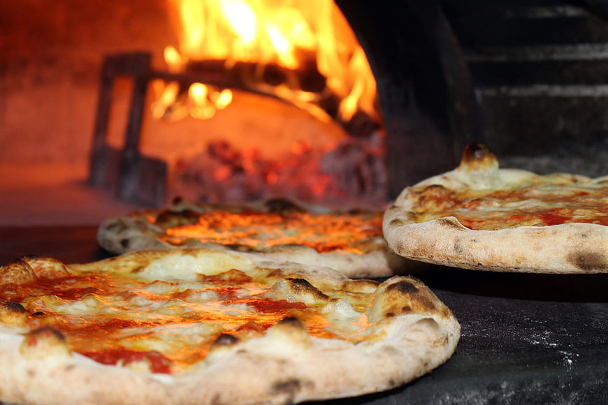 Freshly Baked Wood-Fired Pizzas in a Pizzeria