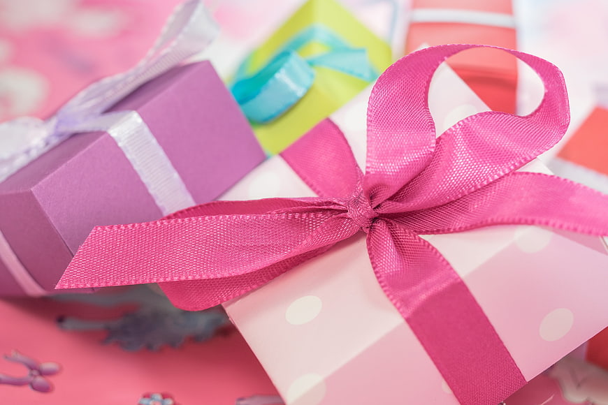 Close-up of pink gift boxes with satin ribbons