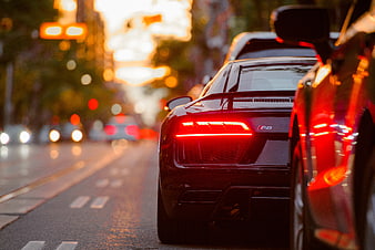 Rear View of Black Audi R8 on City Street at Sunset